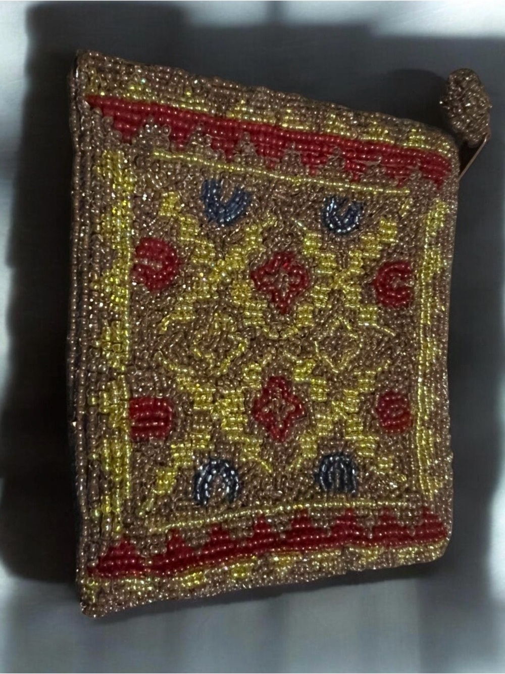 vintage beaded coin purse with geometric and floral patterns.